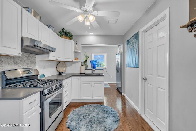 19 Gravelly Point Rd, Highlands, NJ 07732 - kitchen featuring appliances with stainless steel finishes, under cabinet range hood, open shelves, dark countertops, and tasteful backsplash