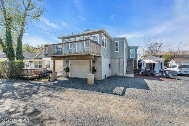 19 Gravelly Point Rd, Highlands, NJ 07732 - view of front facade featuring gravel driveway, a deck, and a garage