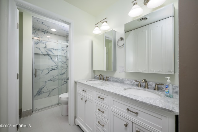 full bathroom featuring toilet, a sink, and a marble finish shower