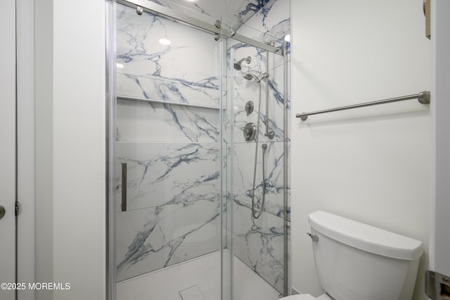 full bath with toilet and a marble finish shower