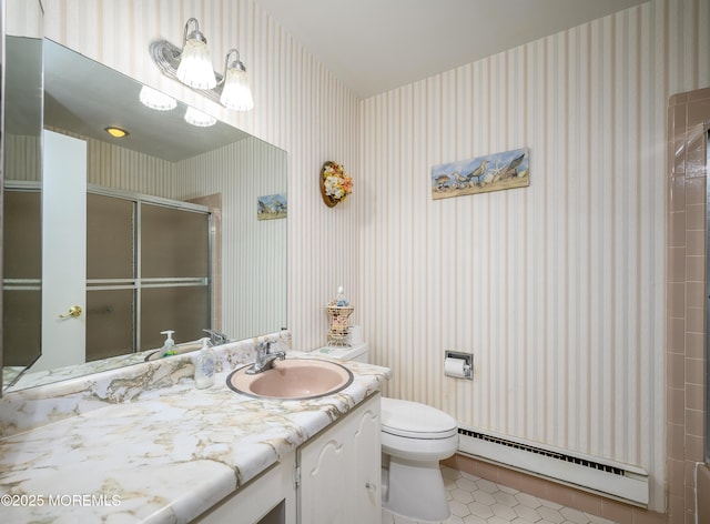 bathroom with wallpapered walls, a shower with door, toilet, vanity, and a baseboard radiator