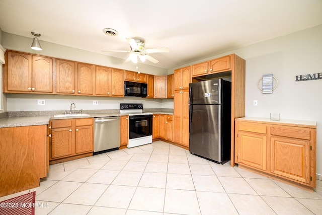 kitchen featuring a ceiling fan, a sink, stainless steel appliances, light countertops, and visible vents