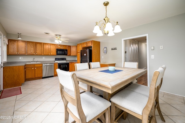 dining space with ceiling fan with notable chandelier, baseboards, and light tile patterned floors