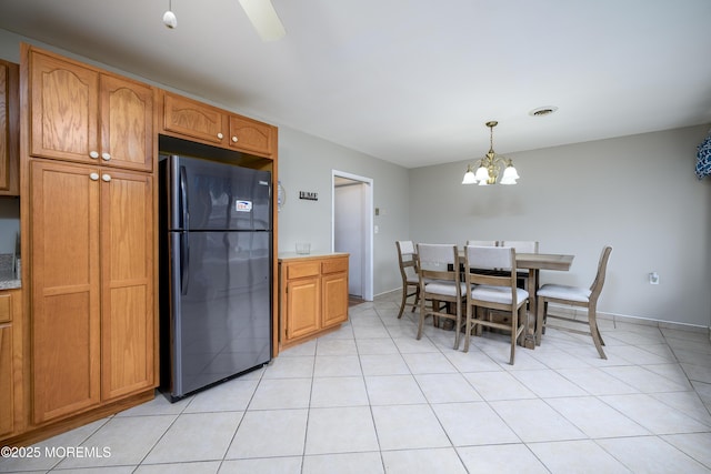 dining space with visible vents, an inviting chandelier, and light tile patterned flooring