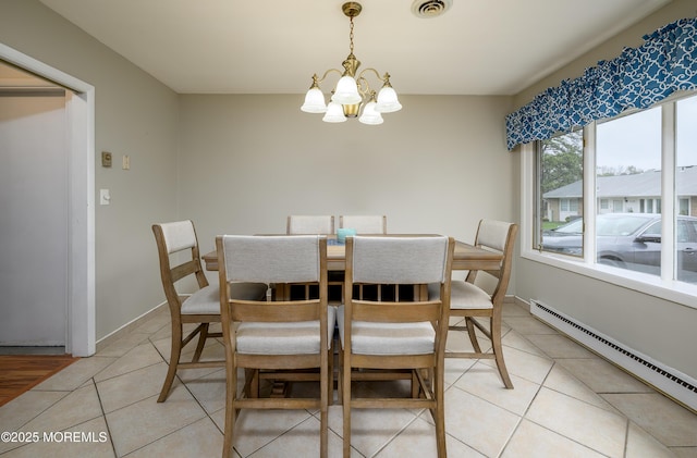 dining space with baseboard heating, visible vents, an inviting chandelier, and light tile patterned floors