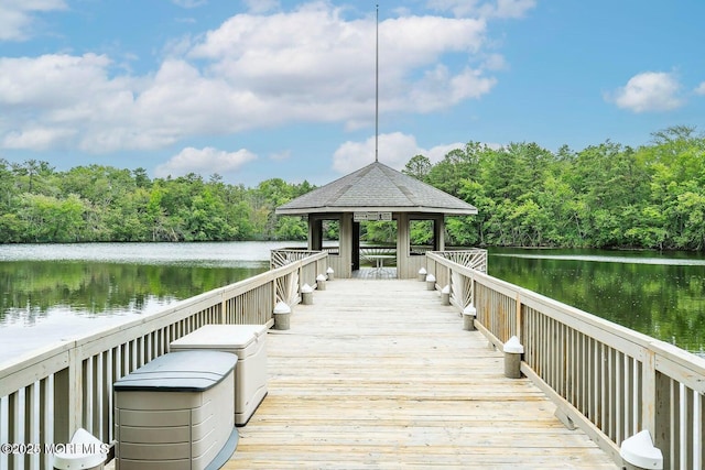 dock area featuring a forest view, a gazebo, and a water view