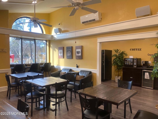 dining space featuring wood finished floors, an AC wall unit, high vaulted ceiling, and ceiling fan