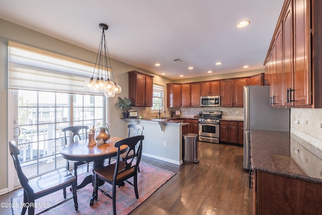 dining space with recessed lighting and dark wood finished floors