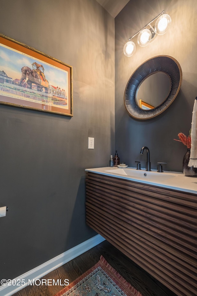 bathroom featuring baseboards and a sink