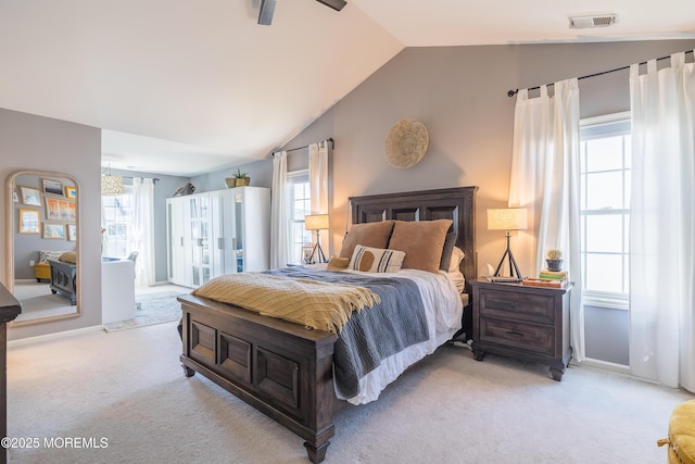 bedroom with visible vents, baseboards, vaulted ceiling, and light carpet