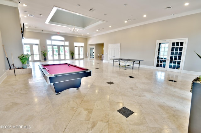 recreation room with crown molding, visible vents, baseboards, a tray ceiling, and french doors