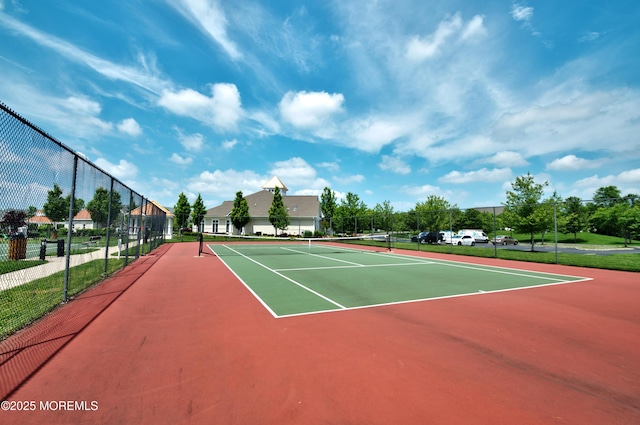 view of tennis court featuring fence