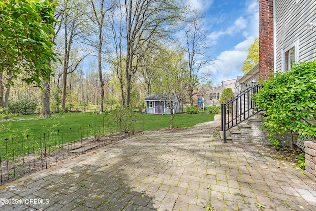 view of patio / terrace featuring an outdoor structure and stairs