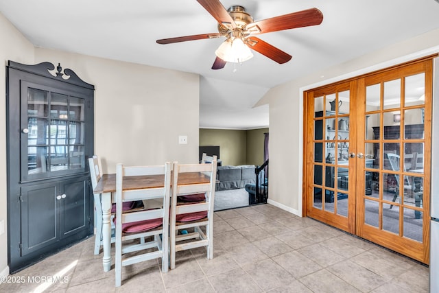 dining room featuring ceiling fan, tile patterned flooring, lofted ceiling, baseboards, and french doors