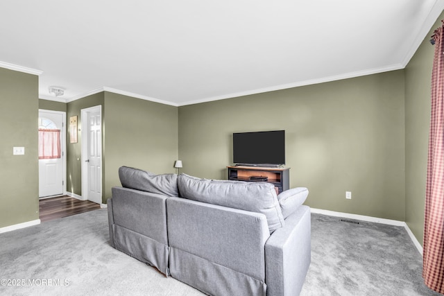 living area featuring carpet, baseboards, and ornamental molding