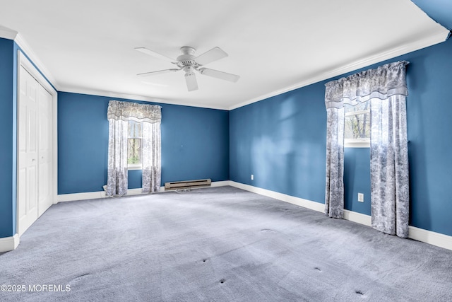 empty room featuring ornamental molding, a ceiling fan, carpet, and baseboard heating