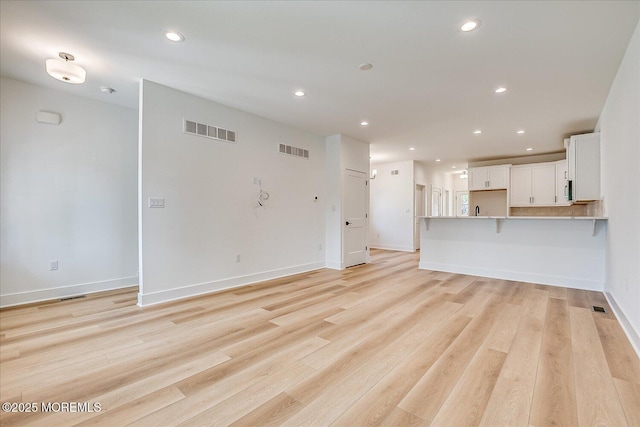 unfurnished living room featuring recessed lighting, visible vents, and light wood-style floors