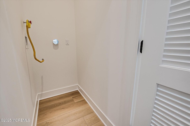 interior space with baseboards and light wood-style floors