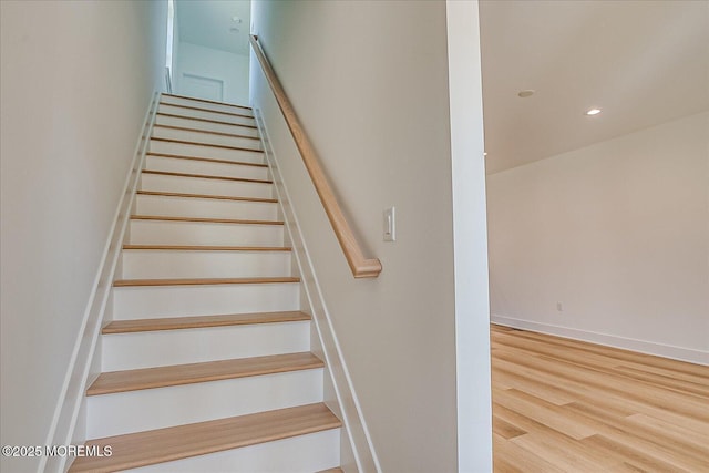 staircase featuring recessed lighting, baseboards, and wood finished floors