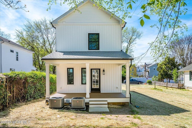 rear view of property with central AC, covered porch, and fence