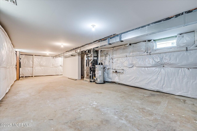 below grade area with visible vents, heating unit, and water heater