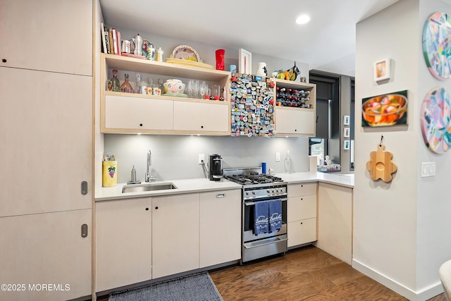601 Bangs Ave Unit 908, Asbury Park, NJ 07712 - kitchen with a sink, stainless steel range with gas stovetop, light countertops, dark wood finished floors, and recessed lighting