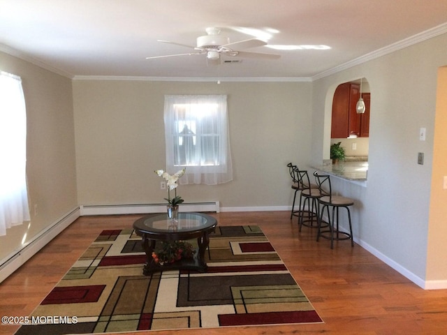 177 Pulaski Blvd, Toms River, NJ 08757 - living area with ornamental molding, wood finished floors, a baseboard heating unit, arched walkways, and ceiling fan