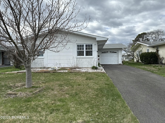 single story home with a front yard, driveway, and an attached garage