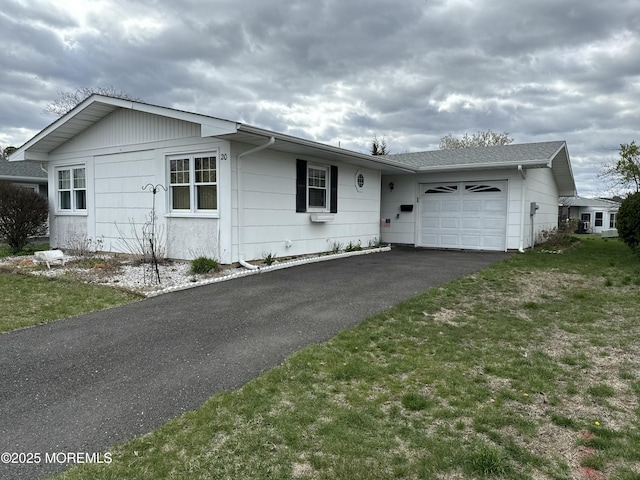 ranch-style home with a garage and driveway