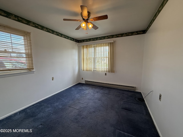 spare room with plenty of natural light, carpet flooring, a baseboard heating unit, and a ceiling fan