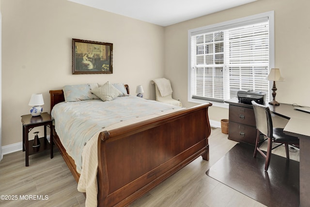 bedroom featuring baseboards and light wood-style flooring