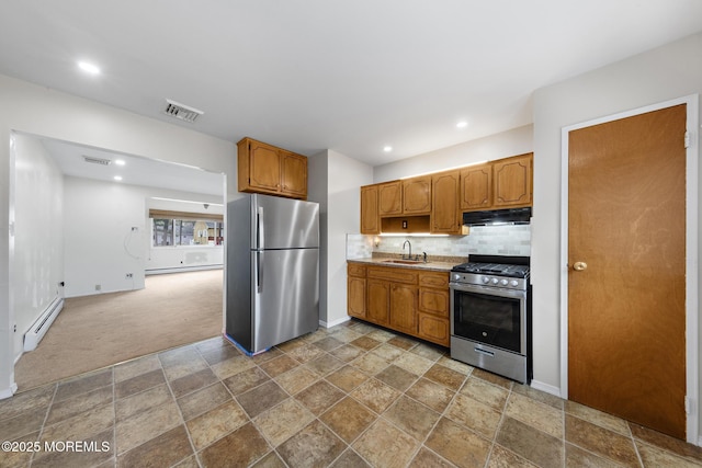 14B S Heron St, Manchester, NJ 08759 - kitchen featuring stainless steel appliances, baseboard heating, a sink, under cabinet range hood, and light countertops
