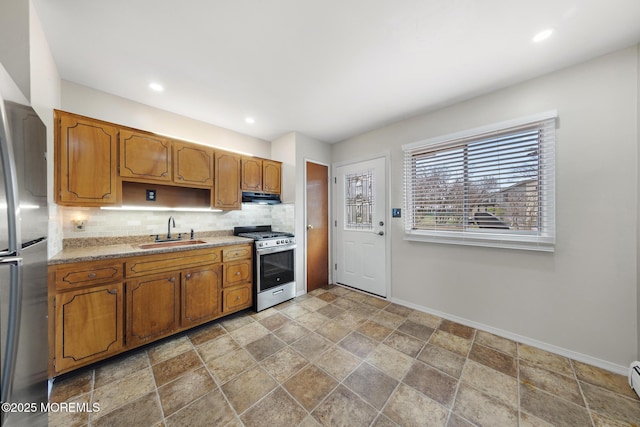 14B S Heron St, Manchester, NJ 08759 - kitchen featuring stainless steel appliances, a sink, under cabinet range hood, baseboards, and decorative backsplash