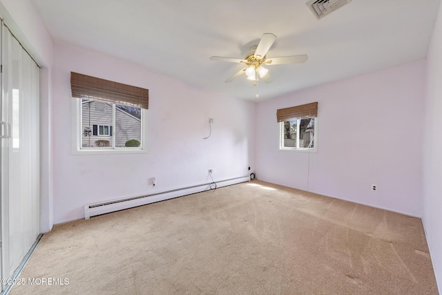 14B S Heron St, Manchester, NJ 08759 - carpeted empty room with a baseboard heating unit and ceiling fan