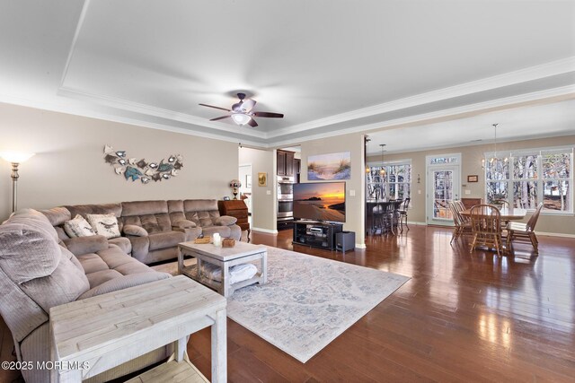311 Newport Way, Little Egg Harbor, NJ 08087 - living area featuring ceiling fan with notable chandelier, a raised ceiling, dark wood finished floors, baseboards, and ornamental molding