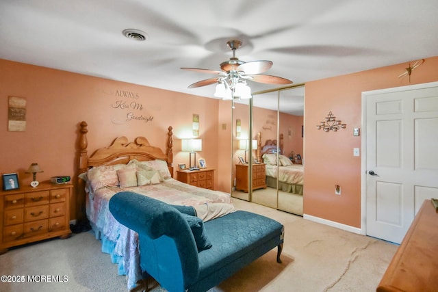 bedroom featuring visible vents, ceiling fan, a closet, and carpet