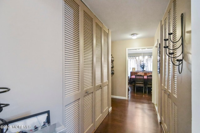 hall featuring baseboards and wood finished floors