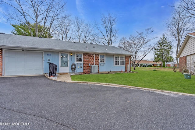 1237A Hamilton Ct, Lakewood, NJ 08701 - single story home featuring driveway, cooling unit, an attached garage, a front yard, and brick siding