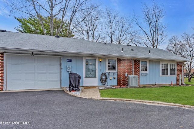 1237A Hamilton Ct, Lakewood, NJ 08701 - ranch-style house featuring cooling unit, a front lawn, brick siding, a garage, and driveway