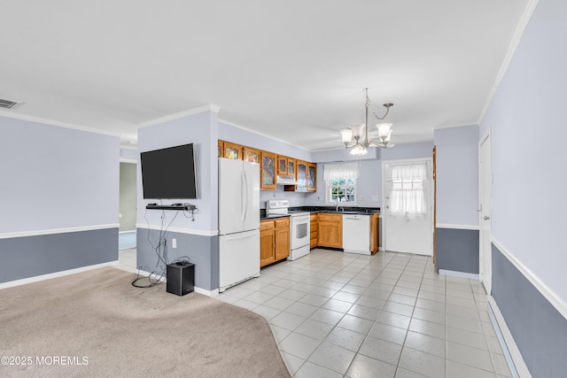 1237A Hamilton Ct, Lakewood, NJ 08701 - kitchen with white appliances, under cabinet range hood, dark countertops, a notable chandelier, and baseboards