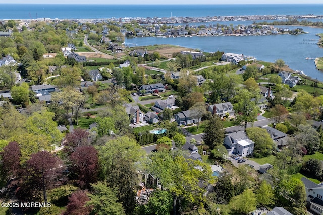drone / aerial view with a residential view and a water view