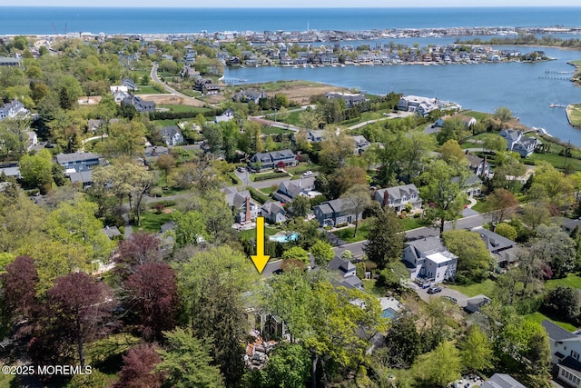 drone / aerial view featuring a water view and a residential view