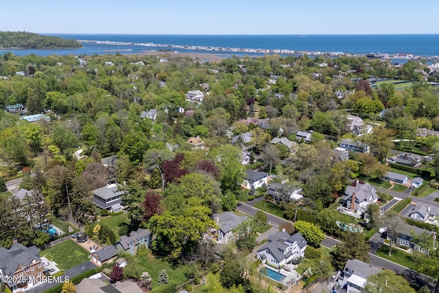 drone / aerial view featuring a residential view and a water view