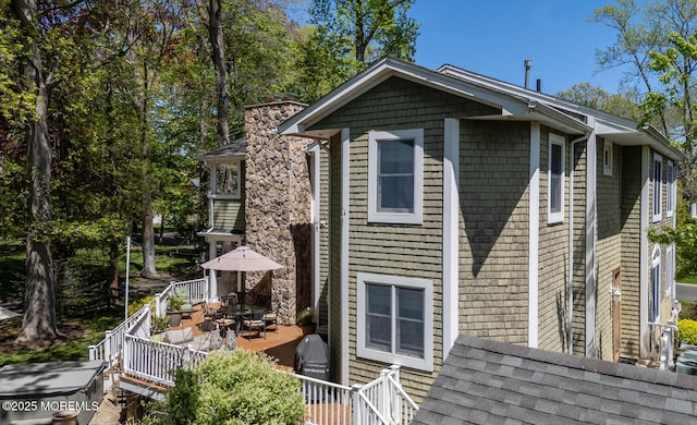 view of home's exterior with a wooden deck and outdoor dining space