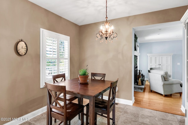 dining room featuring baseboards and a chandelier