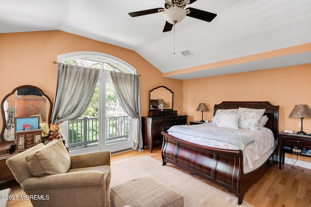 bedroom with visible vents, access to outside, a ceiling fan, light wood finished floors, and vaulted ceiling