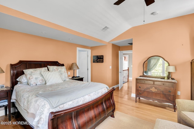 bedroom with ceiling fan, visible vents, wood finished floors, and lofted ceiling