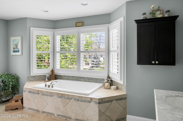 bathroom featuring tile patterned flooring and a bath