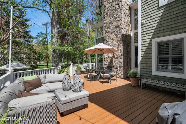 wooden terrace featuring an outdoor hangout area and outdoor dining space