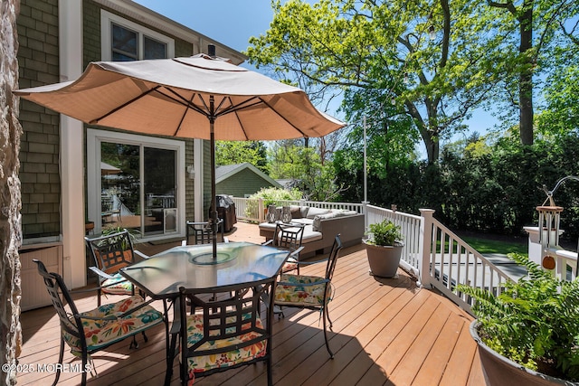 wooden terrace featuring outdoor dining area and outdoor lounge area